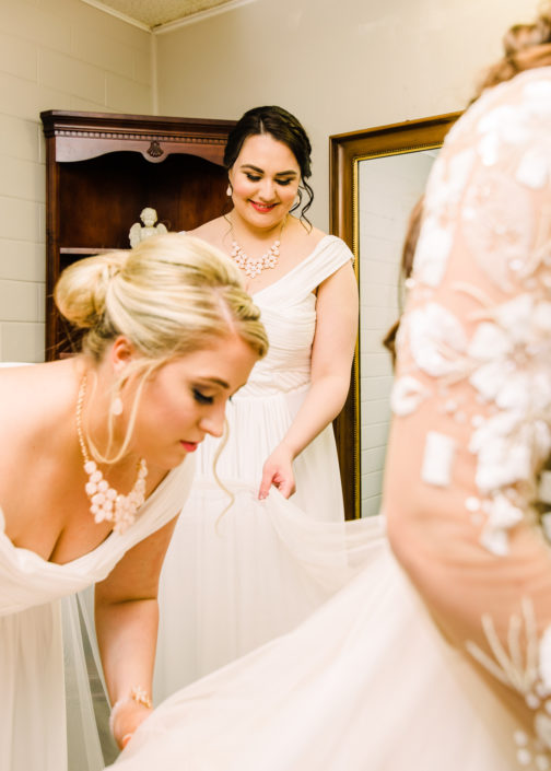 Bridesmaids helping out bride in Houston