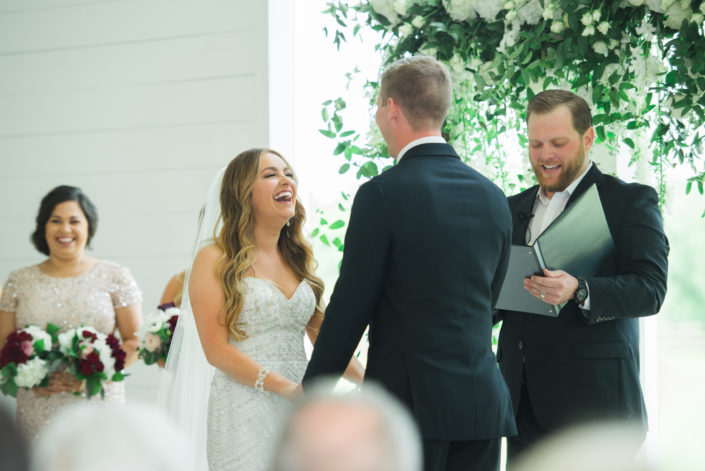 Bride laughing at ceremony at the farmhouse in Houston
