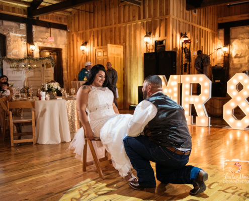 Groom taking garter off at The Springs Event Venue in Angleton, Texas