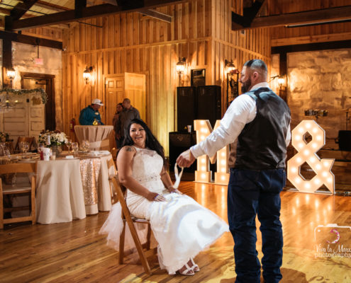 The groom takes garter off at The Springs Events Venue in Angleton, Texas