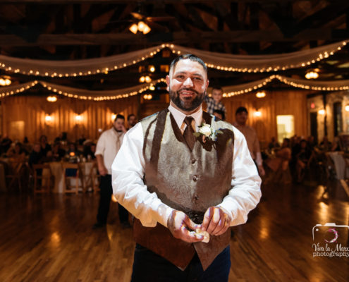 Groom about to toss the garter at The Springs Event Venue Angleton