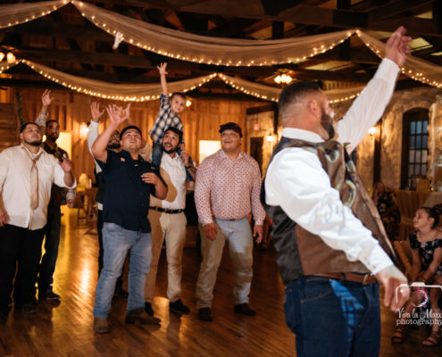Groom tossing the garter at The Springs Event Venue Angleton